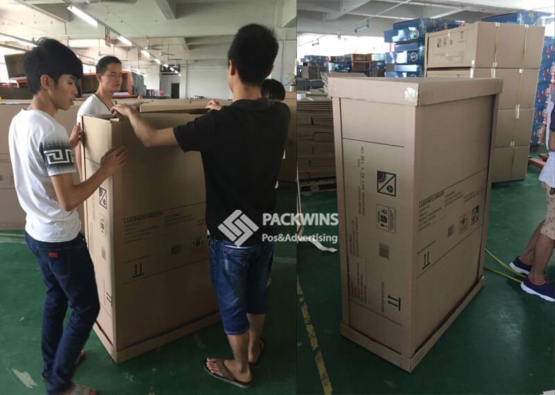 A team packing out cardboard displays in a warehouse