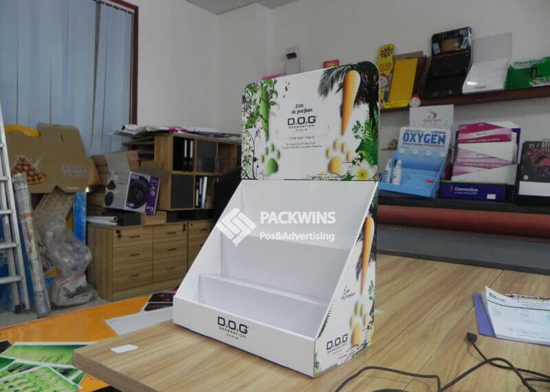 A finished packaging prototype sitting next to a pallet of identical, mass-produced, retail-ready packages.