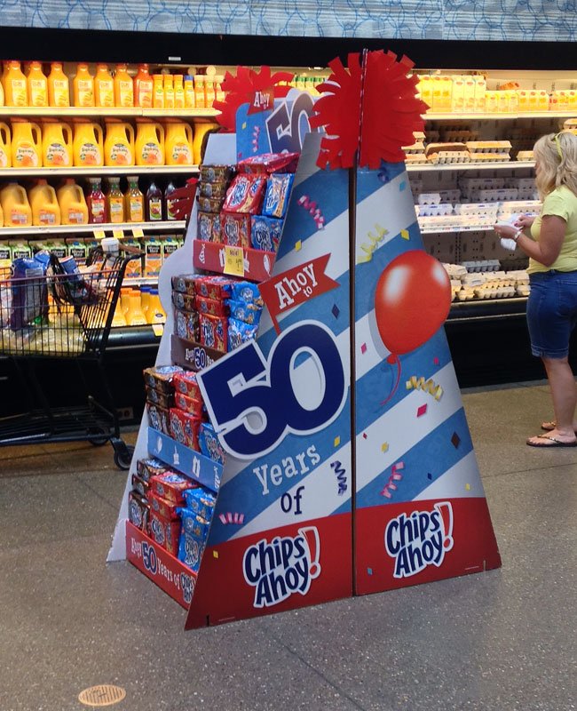 Why In-Aisle Displays Capture Attention A shopper looking at an interactive in-aisle display